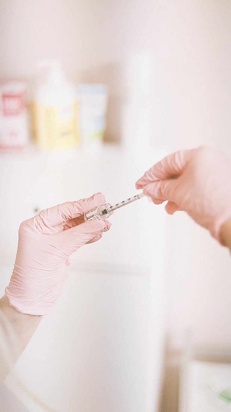 A professional prepares a cosmetic injection in a modern spa, focusing on skincare and wellness.